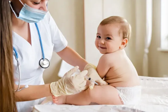 A nurse caring for a baby during a well visit